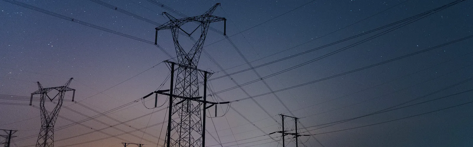 High-voltage transmission towers at dusk